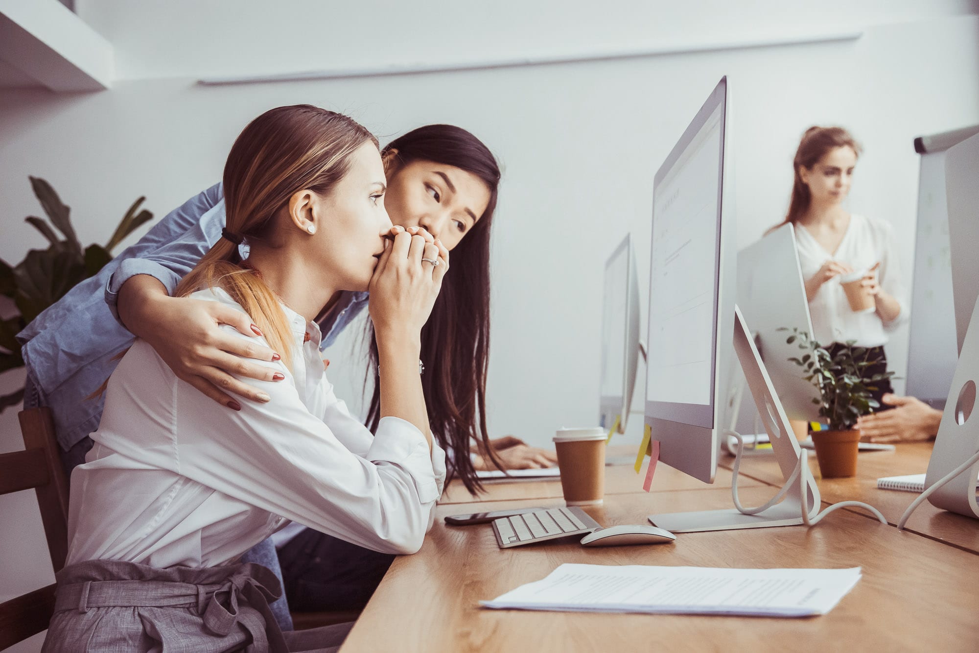 support-at-work-edit Two young women looking at a screen in an office